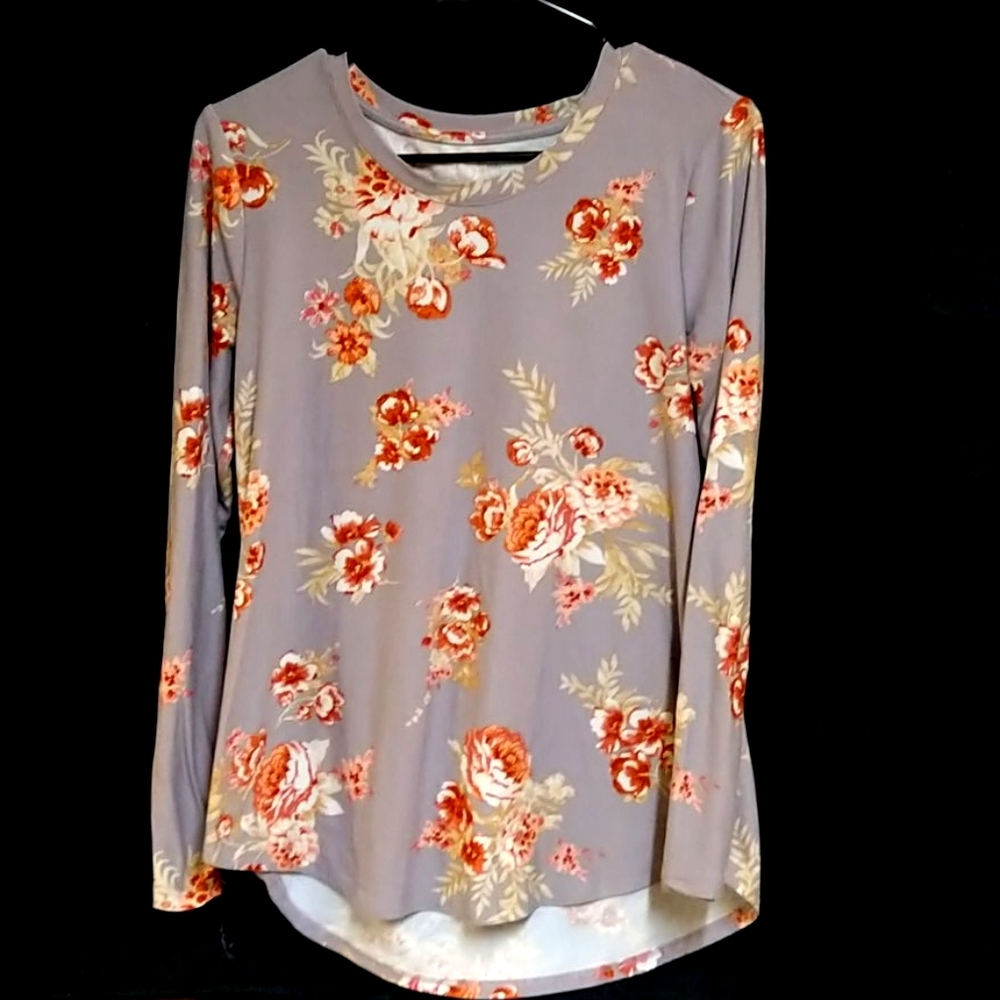 A pastel purple long sleeve shirt with roses on it